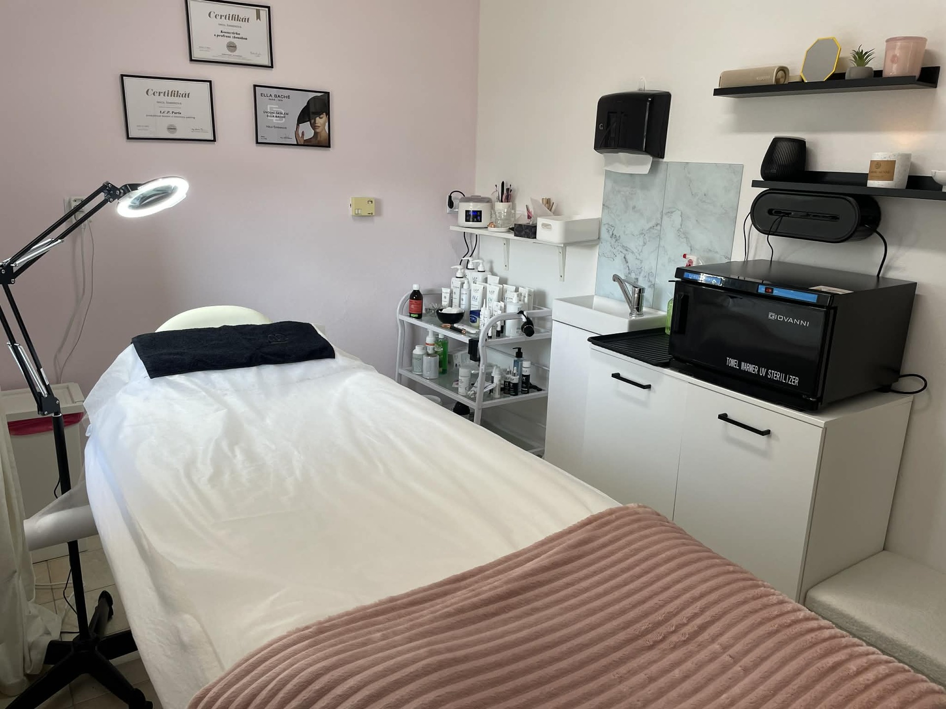 Treatment room with bed and certificates